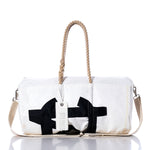 Vintage Melges Duffel by Sea Bags—crafted from recycled sail cloth, this white duffel bag showcases a bold black abstract design and is equipped with durable hemp rope handles, a beige shoulder strap, and a white “Sea Bags” tag attached to the handle. by Sea Bags