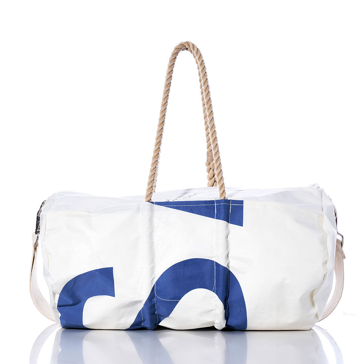 The Sea Bags Vintage US Duffel, crafted from recycled sail cloth in white and blue, features rope handles and a shoulder strap, and is photographed on a white reflective surface. by Sea Bags