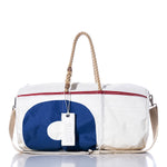 The Sea Bags Vintage Blue 9 Duffel is expertly crafted from recycled sail cloth and features a white exterior with a blue design, hemp rope handles, a beige shoulder strap, and a SEA BAGS tag attached to one handle. by Sea Bags