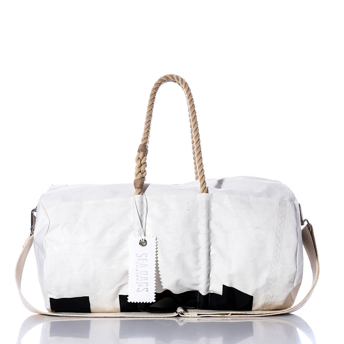 The Vintage International 14 Duffel by Sea Bags is crafted from recycled sail cloth and features tan rope handles, a beige shoulder strap, and a white tag labeled Sea Bags. This vintage white duffel is displayed against a white background. by Sea Bags