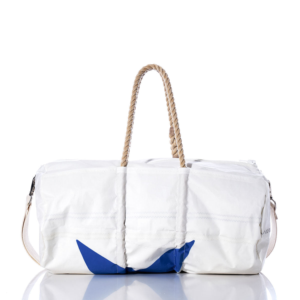 The Sea Bags Vintage Blue Star Duffel, crafted from recycled sail cloth, features hemp rope handles, a beige shoulder strap, and a blue accent on the lower left. The bag is displayed on a reflective surface. by Sea Bags