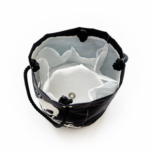 Top view of the Jolly Roger Beverage Bucket by Sea Bags, crafted from recycled sail cloth with classic rope handles and internal pockets, featuring a grommet at the bottom center—perfect for use as a beer bucket or portable drink cooler. by Sea Bags
