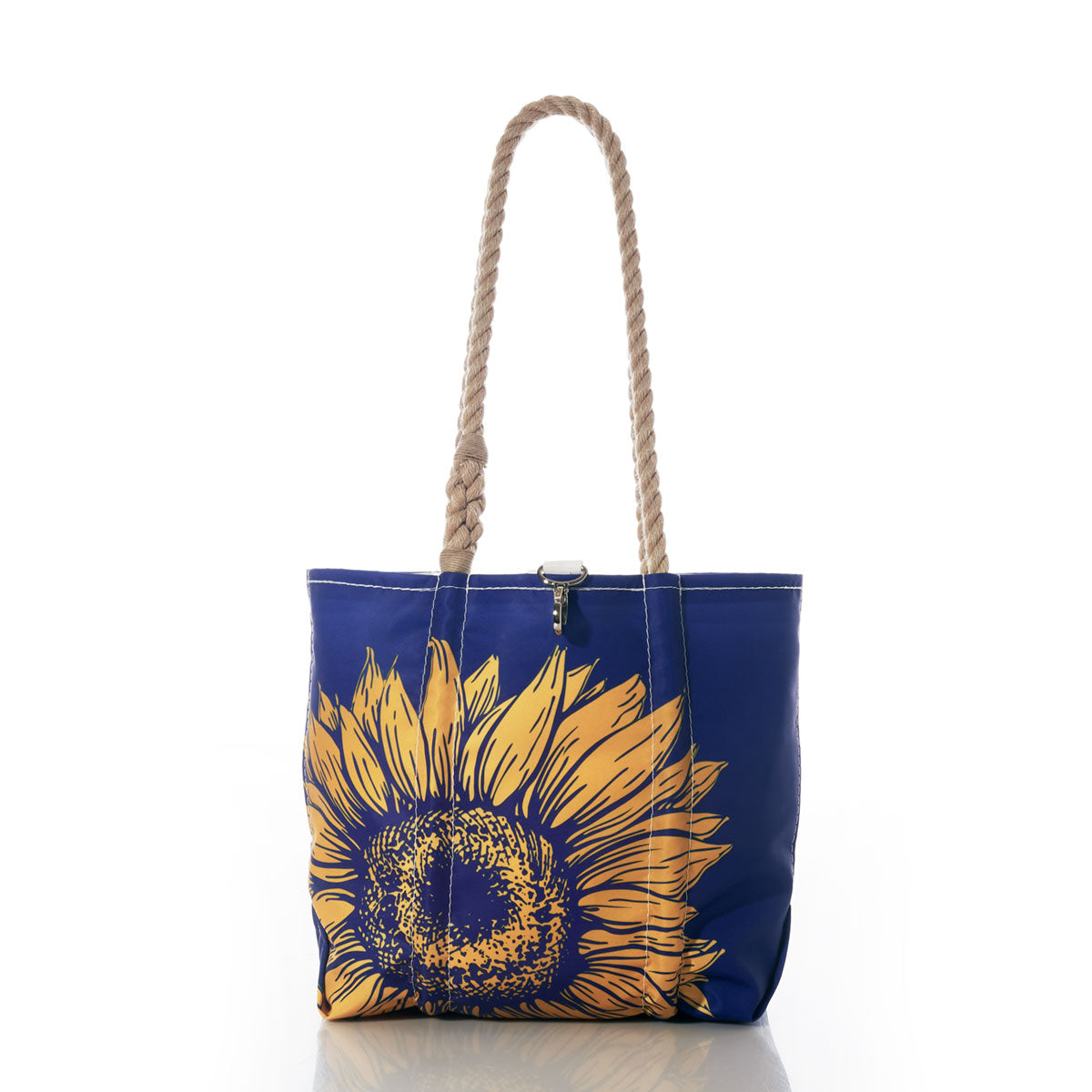 The Sunflower Handbag by Sea Bags features a large yellow sunflower graphic and sturdy rope handles, making it perfect for nature lovers who appreciate bold floral designs. Photographed on a white background. by Sea Bags