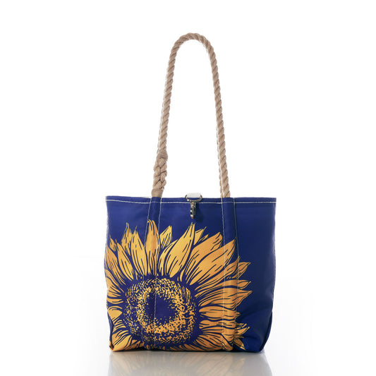 The Sunflower Handbag by Sea Bags features a large yellow sunflower graphic and sturdy rope handles, making it perfect for nature lovers who appreciate bold floral designs. Photographed on a white background. by Sea Bags