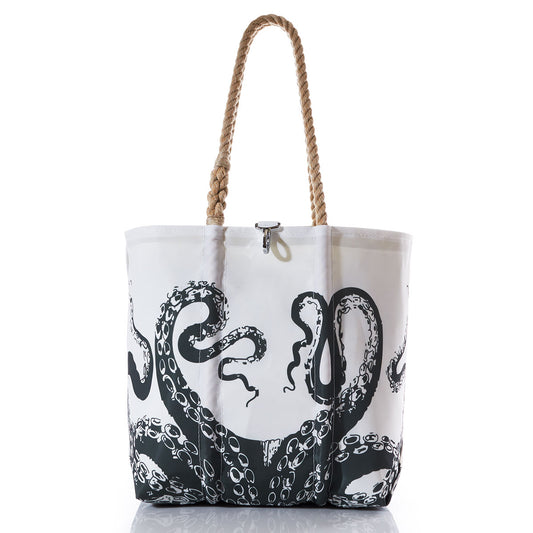 The Octopus Medium Tote with Clasp by Sea Bags features a striking black octopus tentacle design on white, complemented by two tan rope handles. Photographed against a white background, this tote is the perfect oceanography accessory—evoking the spirit of exploration and reminiscent of iconic voyages like the HMS Challenger or Darwin’s Origin of Species. by Sea Bags