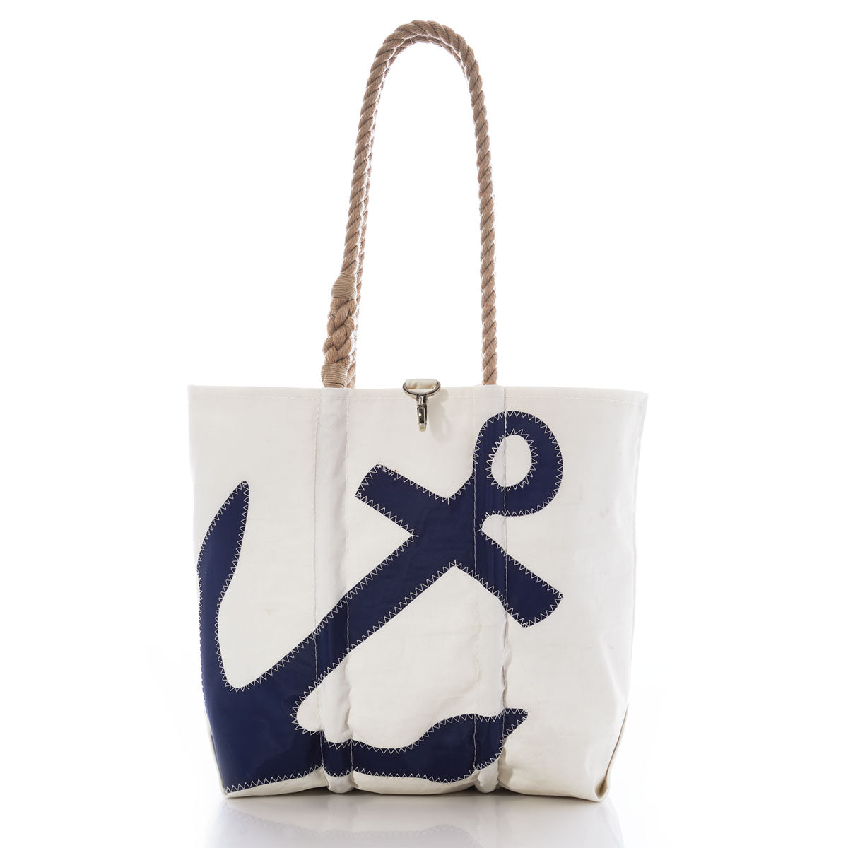 The Sea Bags Navy Anchor Medium Tote with Hemp Rope features a white canvas body with a navy blue anchor design and sturdy hemp rope handles, crafted for durability and inspired by recycled sail bags. Photographed on a white background. by Sea Bags
