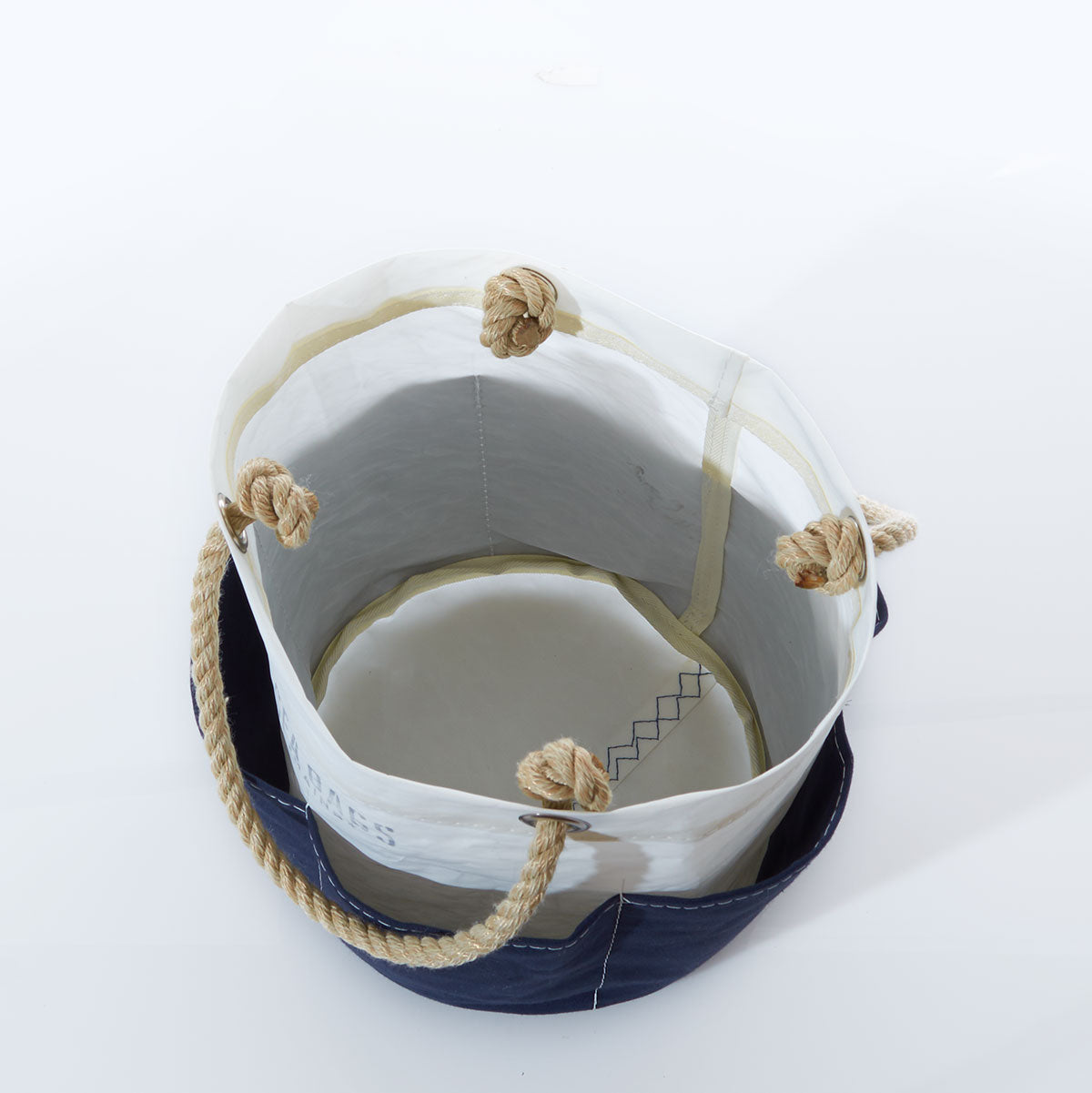 The All Purpose Navy Tool Bucket Bag by Sea Bags is an open-top canvas bucket bag with rope handles and knotted ends, shown from above on a white background—an ideal and stylish way to organize your gardening tools. by Sea Bags
