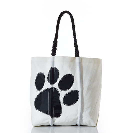 Sea Bags Paw Print Medium Tote with Clasp and Hanging Pocket, crafted from recycled sailcloth, features black rope handles and a bold black paw print on the front. Photographed against a white background, this tote is ideal for dog lovers or as a stylish pet supply organizer. by Sea Bags