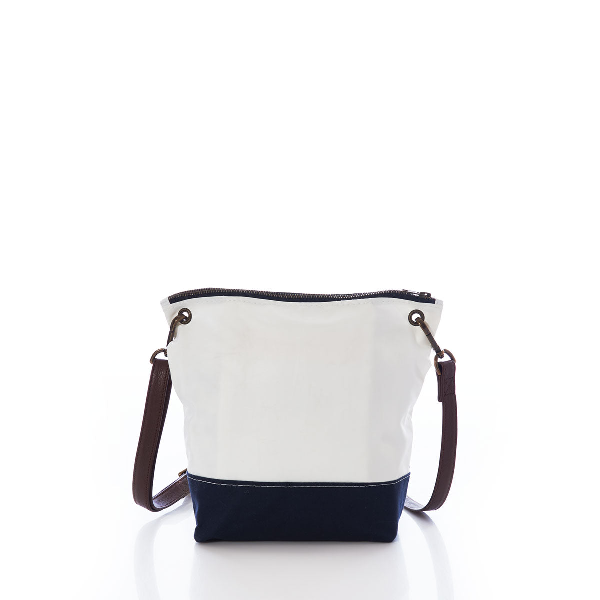 The Sea Bags Chebeague Crossbody Bag features a white and navy color-block design, a brown premium leather handle, and a zipper closure. Crafted from durable Dacron sailcloth, it is photographed against a white background. by Sea Bags
