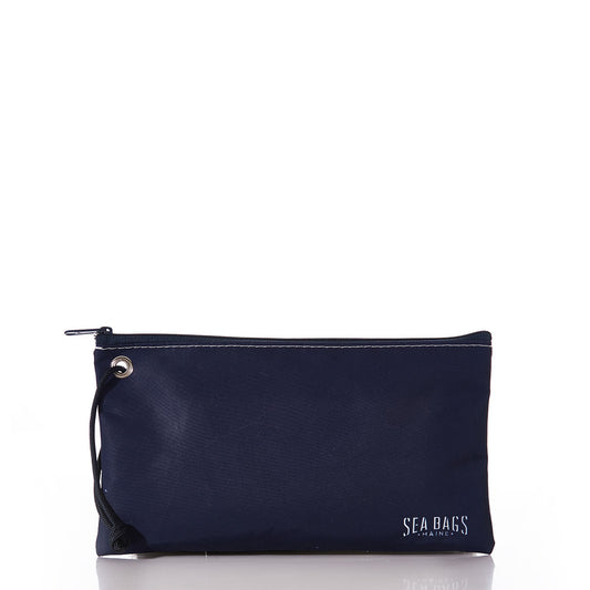 Introducing the White on Navy Sand Dollar Large Wristlet from Sea Bags—an eco-friendly navy blue zippered pouch featuring a small rope loop on the left side and “Sea Bags Maine” printed in white in the lower right corner. Perfect for carrying your essentials, whether you’re headed to the beach or using it for everyday needs. by Sea Bags