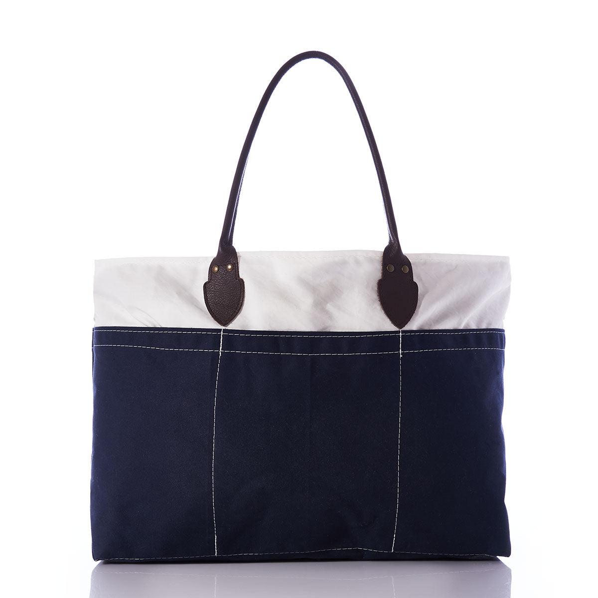 The Chebeague Large Travel Tote by Sea Bags is crafted from water-resistant canvas, featuring a dark blue lower half and a white upper section with coordinating white stitching, complemented by two dark brown handles—all showcased against a plain white background. by Sea Bags