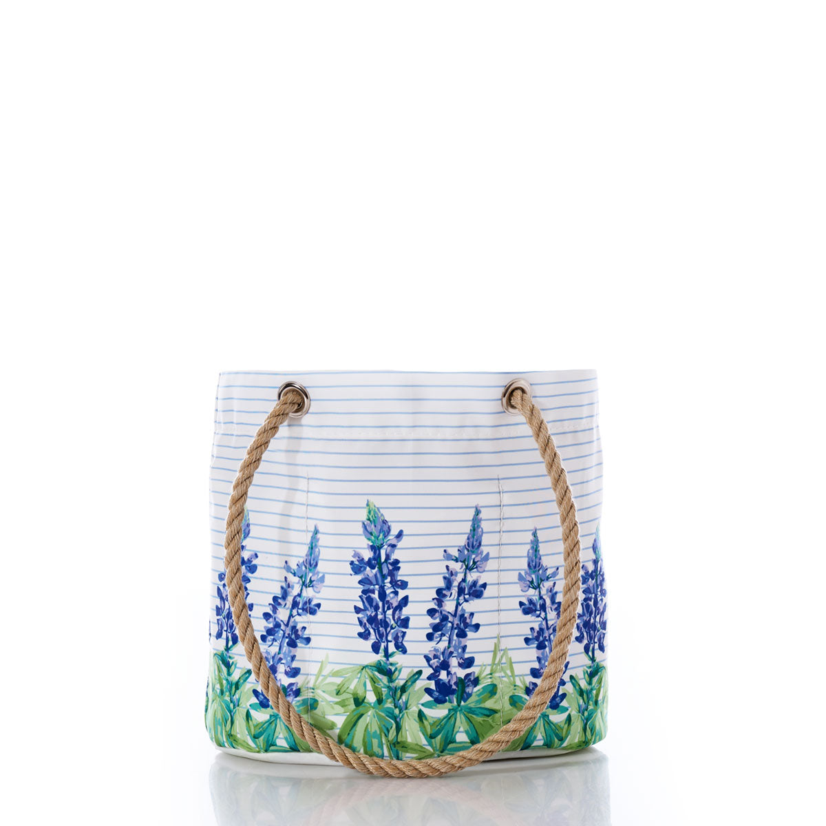 Introducing the Sea Bags Lupine on Sailor Stripe Essential Handbag—a white tote featuring a captivating blue floral lupine design over classic horizontal sailor stripes. Crafted from recycled sail cloth for an eco-friendly touch, this lightweight and practical handbag boasts two sturdy rope handles. Perfect for everyday use and displayed elegantly against a white background. by Sea Bags