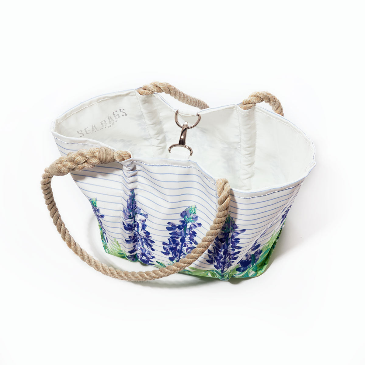 Introducing the Lupine Sailor Stripe Handbag by Sea Bags—a spacious coastal tote crafted from recycled sail cloth, featuring bold stripes, floral prints, a white interior, and sturdy rope handles for both style and sustainability. by Sea Bags