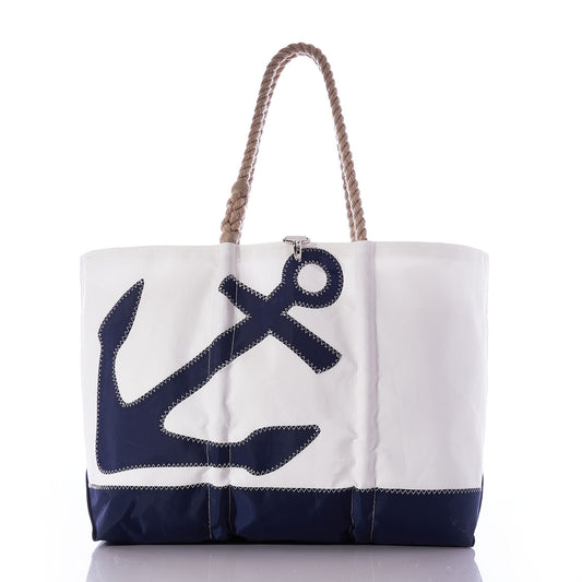 The Sea Bags Navy Anchor Ogunquit Beach Tote is a white and navy canvas beach bag, crafted from recycled sail cloth, featuring a large anchor design and two twisted rope handles, displayed against a white background. by Sea Bags
