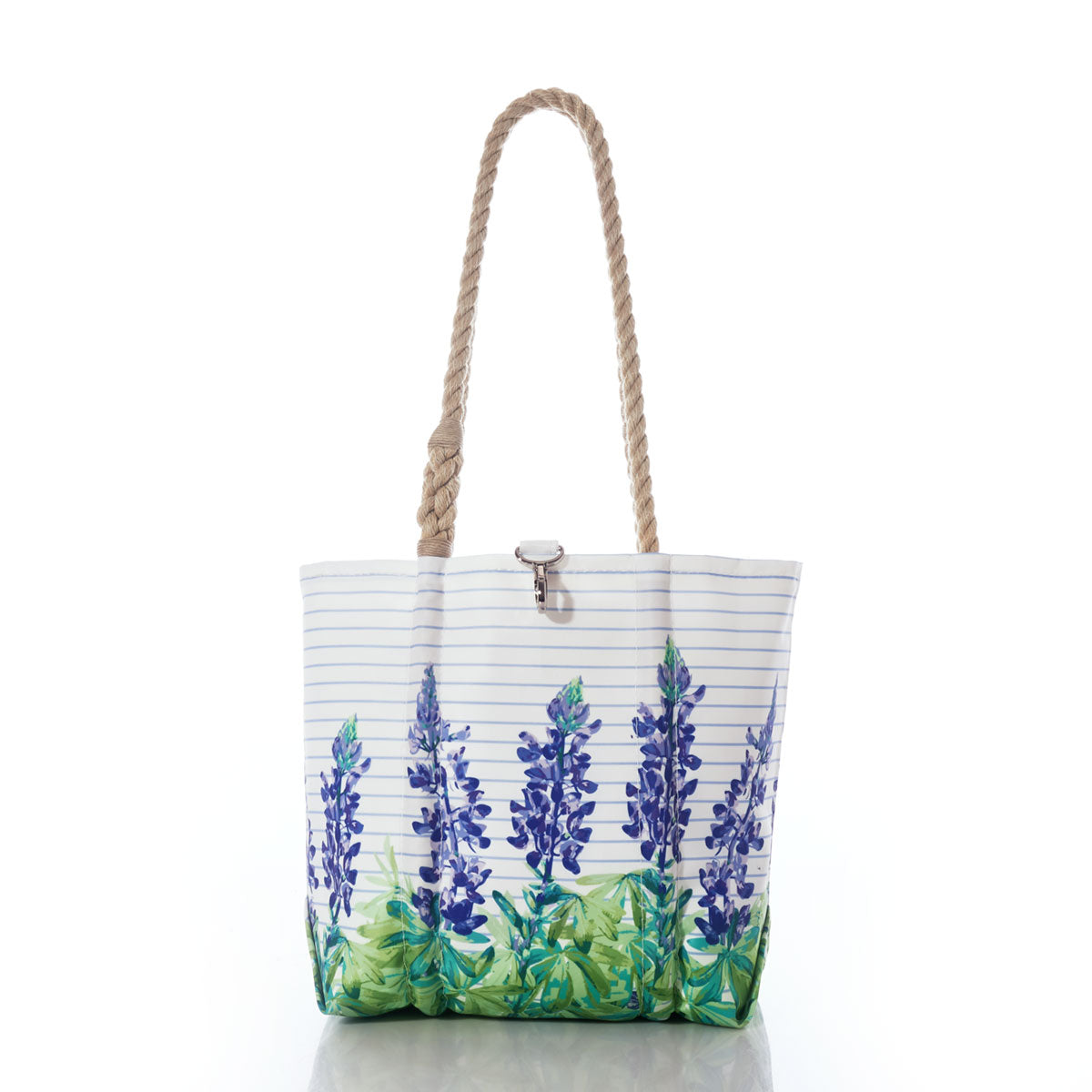 The Lupine Sailor Stripe Handbag by Sea Bags features a white recycled sail cloth design adorned with bluebonnet flower prints, green leaves, blue stripes, tan rope handles, and a silver clasp—shown here against a white background. by Sea Bags
