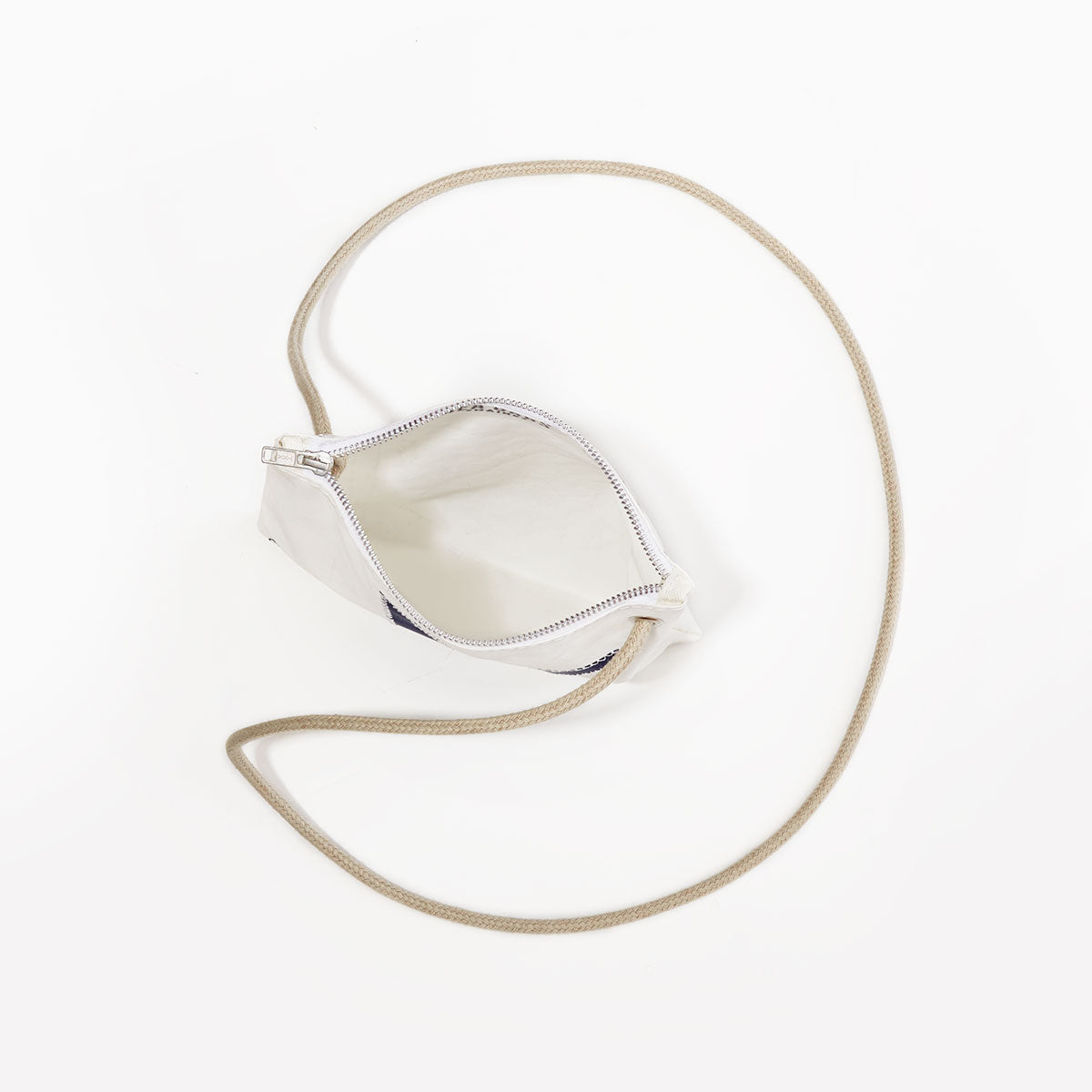 The Multicolor Nautilus Slim Crossbody Bag by Sea Bags, made from recycled sail cloth, features a small design with a white base, a long beige strap, and zippered closure—photographed from above on a plain white background. by Sea Bags