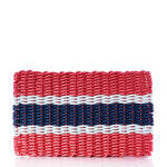Introducing the Fisherman Rope Mat - Navy, Sea Foam  Red Stripe by True: a rectangular woven clutch crafted from eco-friendly, rope-like material. Its bold navy, sea foam, and red horizontal stripes evoke a nautical stripe mat design—making this clutch both stylish and practical. by Sea Bags