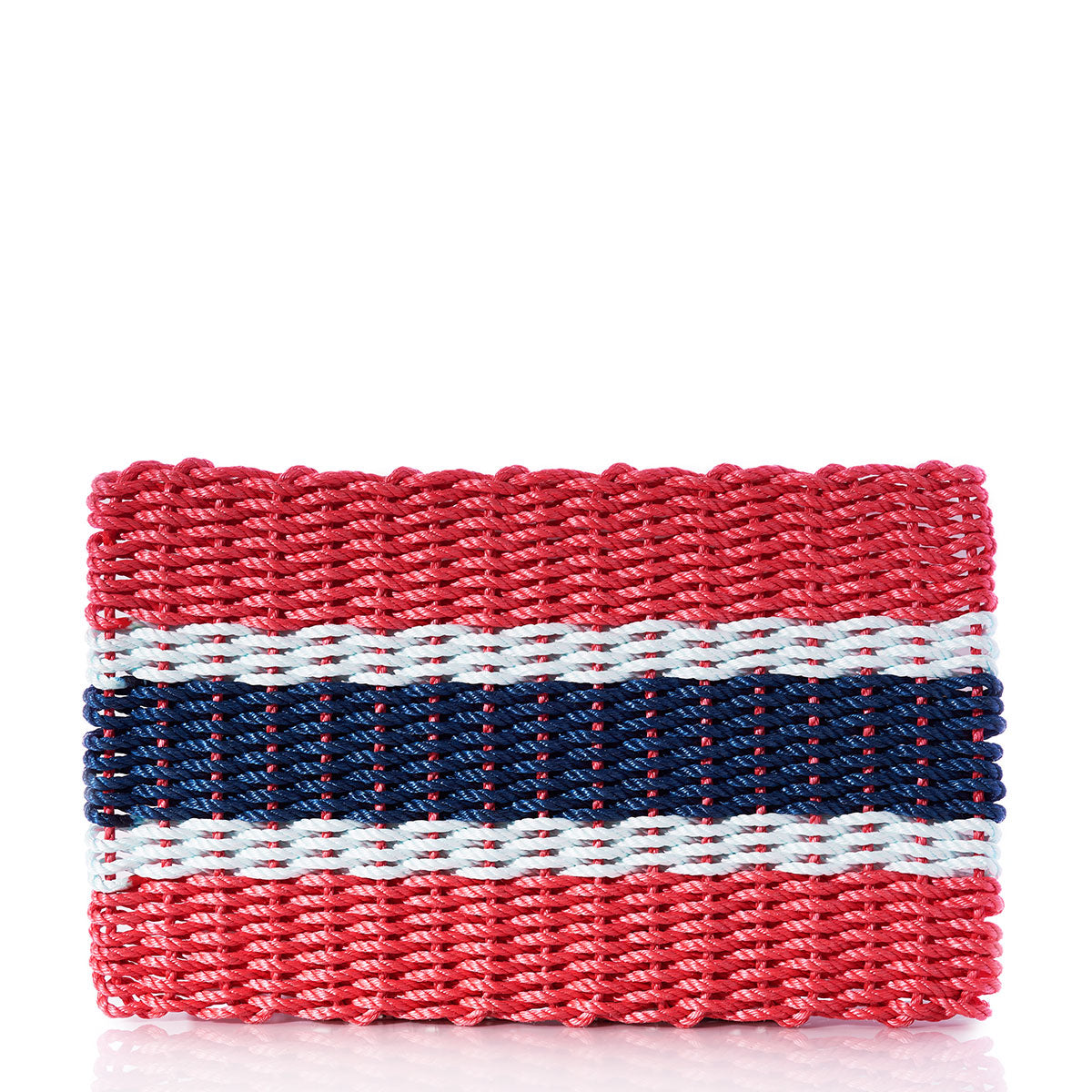 Introducing the Fisherman Rope Mat - Navy, Sea Foam  Red Stripe by True: a rectangular woven clutch crafted from eco-friendly, rope-like material. Its bold navy, sea foam, and red horizontal stripes evoke a nautical stripe mat design—making this clutch both stylish and practical. by Sea Bags
