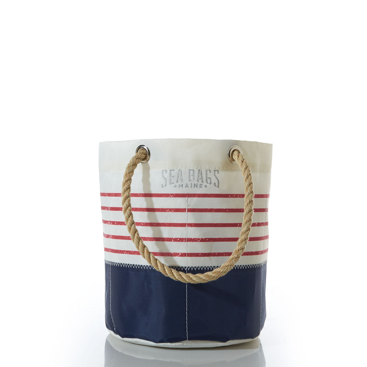 The Red Mariner Stripe Beverage Bucket Bag by Sea Bags features a white and navy canvas design with bold red horizontal stripes, sturdy rope handles, and Sea Bags printed on the upper section. Made from recycled sail cloth, this bag offers both durability and distinctive coastal charm. by Sea Bags