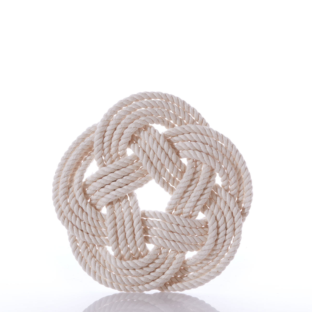 The Nautical Sailor Knot Trivet-Natural by true features a neatly coiled, off-white cotton rope tied in a decorative, flat, circular Turk’s head knot against a plain white background.