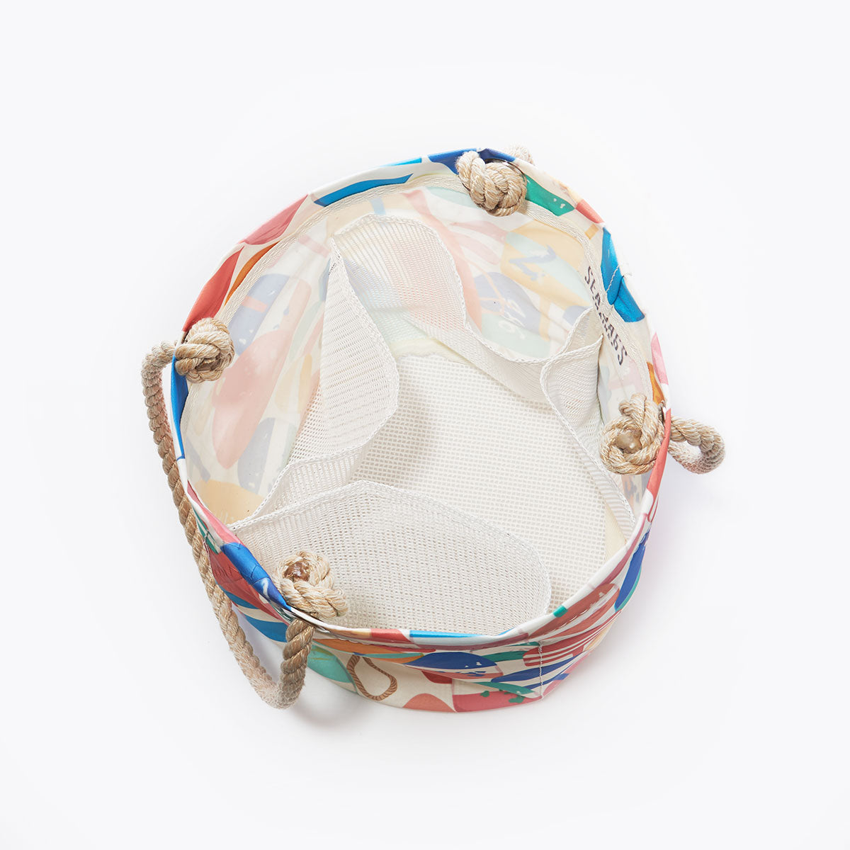 Sea Bags’ Downeast Buoys Beachcomber Bucket is a round, colorful tote bag featuring a mesh interior and sturdy rope handles, evoking the charm of traditional lobster fisherman gifts; shown from above against a plain white background. by Sea Bags