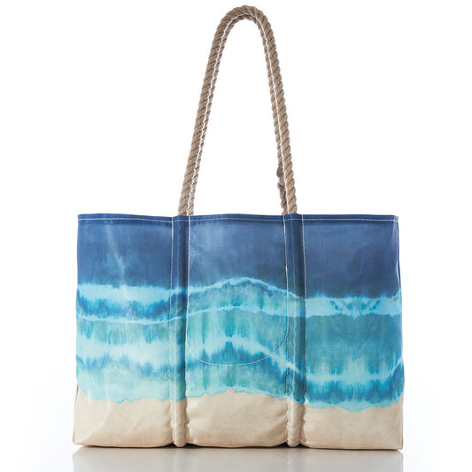 Sea Bags Shoreline Tie Dye Large Tote with Clasp and Hanging Pocket features a blue and beige wave-inspired gradient reminiscent of ocean water meeting sand, crafted from recycled sail cloth for added water resistance. by Sea Bags
