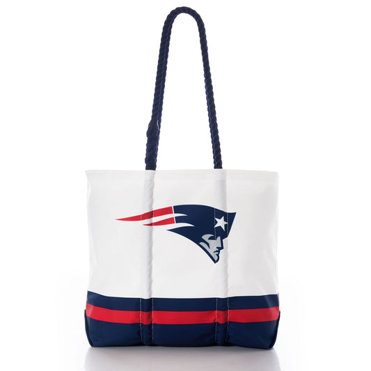 Introducing the New England Patriots Medium Tote by Sea Bags—a stylish and eco-friendly bag crafted from white recycled sail cloth, featuring blue and red stripes at the bottom, the official Patriots logo, and durable navy blue rope handles. Perfect for devoted fans. by Sea Bags