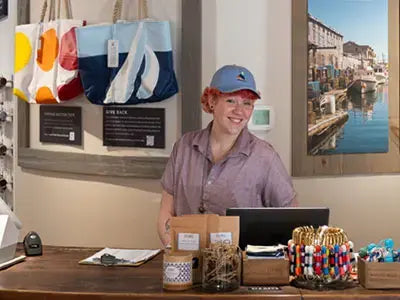 Sea Bags crew member behind the counter at our Flagship Store
