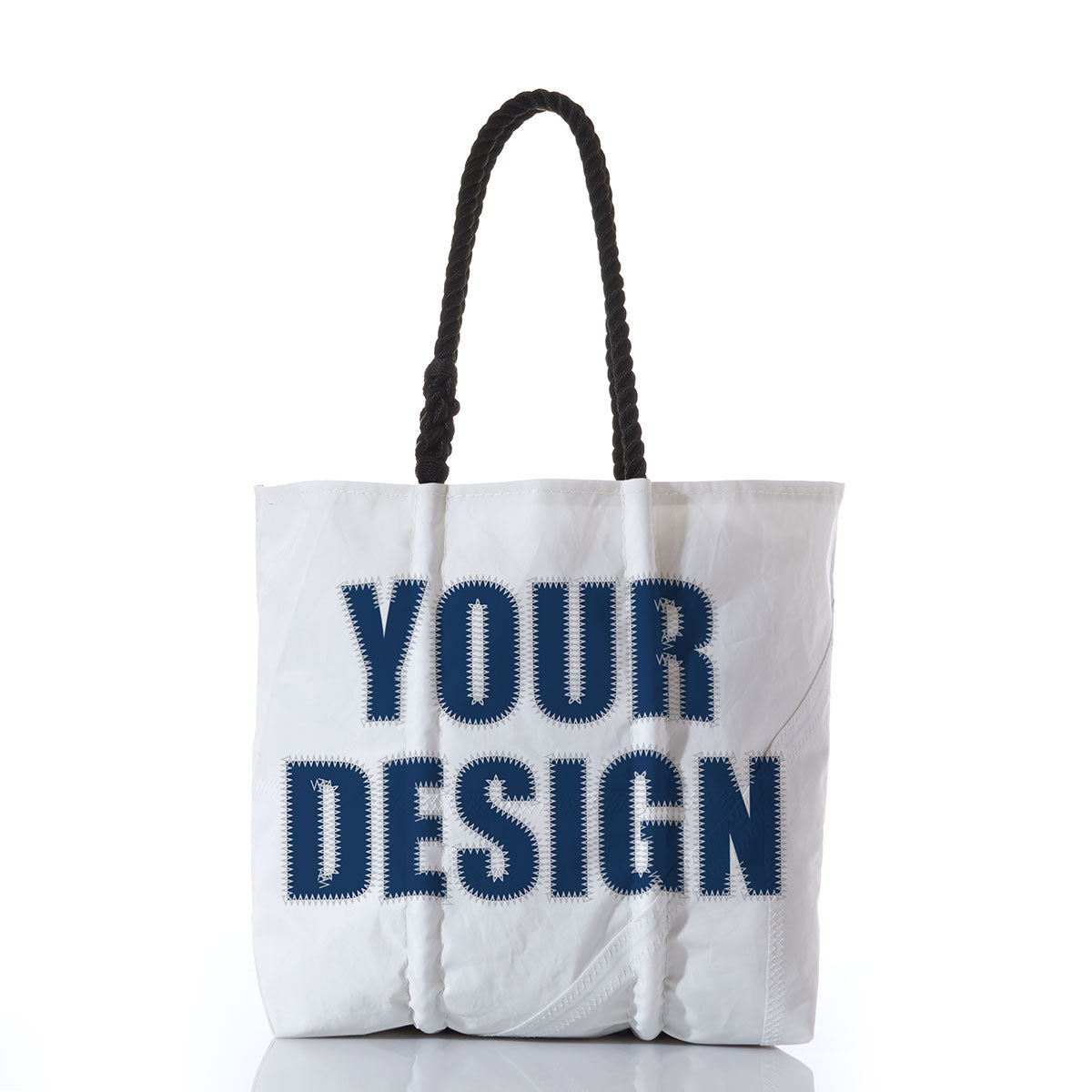 Sea Bags Custom Design Medium Tote featuring sturdy black handles and the phrase YOUR DESIGN printed in large, bold navy blue letters on the front, set against a plain white background. by Sea Bags