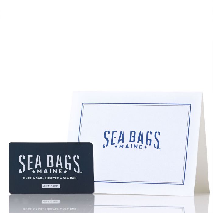 A Mail a Gift Card from Sea Bags is presented alongside a matching white envelope featuring the iconic Sea Bags Maine logo in blue, making it the perfect Maine-inspired gift for any occasion. by Sea Bags