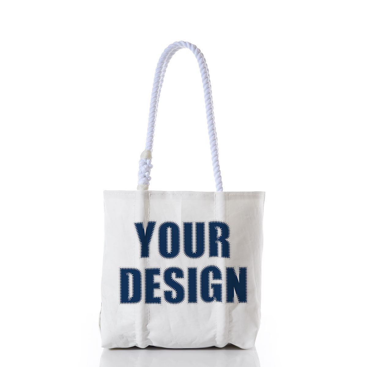 The Sea Bags Custom Design Handbag is shown upright on a white background, featuring sturdy white rope handles and bold navy blue lettering reading YOUR DESIGN on the front—ideal for creating a personalized bag that suits your unique style. by Sea Bags