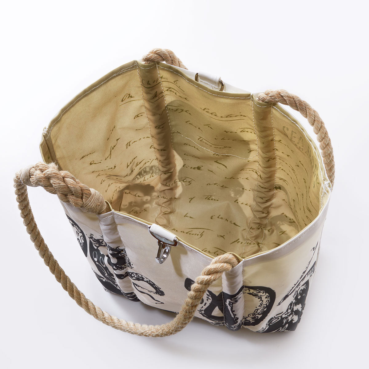 Sea Bags Octopus Handbag is a canvas tote bag crafted from recycled sail cloth, seen from above, featuring sturdy rope handles, a beige interior lined with cursive writing, and a striking black-and-white design on the exterior—an ideal accessory for those with the curious spirit of Charles Darwin. by Sea Bags