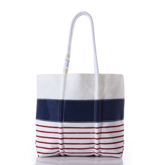 The Red Mariner Stripe Medium Tote by Sea Bags is a nautical-inspired tote bag made from recycled sailcloth, featuring sturdy white rope handles, a crisp white top section, a navy blue stripe across the middle, and vibrant red horizontal stripes along the bottom, displayed against a white background. by Sea Bags