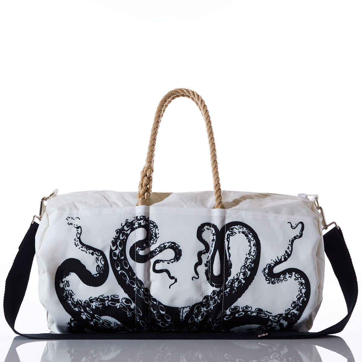 Sea Bags’ Octopus Duffel, crafted from recycled sail cloth, features a bold black octopus tentacle design, sturdy rope handles, a detachable black shoulder strap, and a marine grade zipper—all showcased on a reflective surface. by Sea Bags