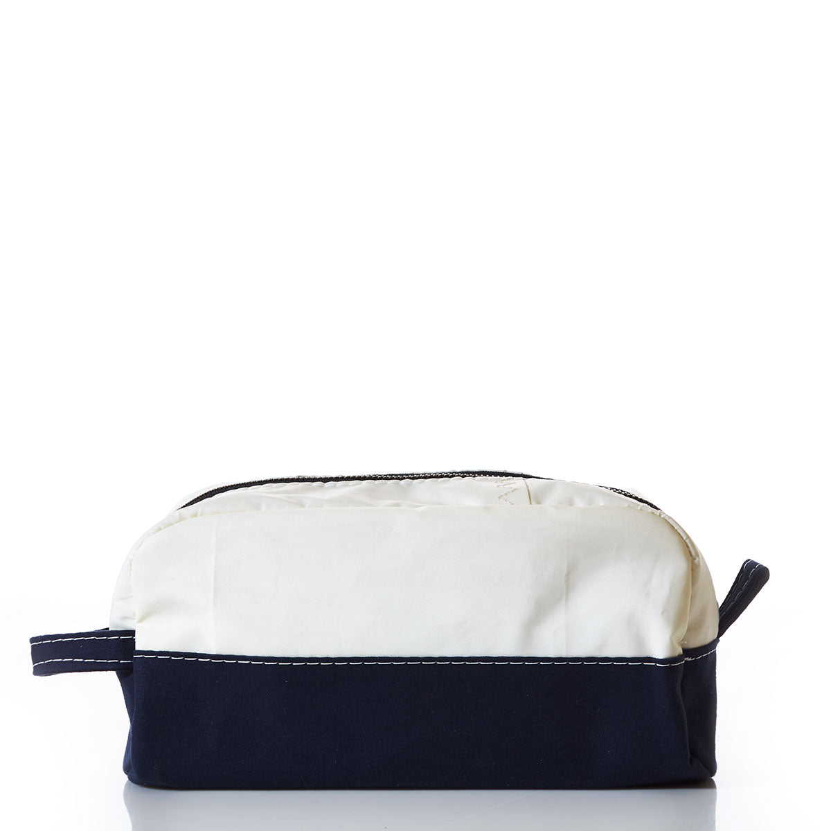 The Sea Bags Chebeague Toiletry Bag is a rectangular zippered pouch from the Chebeague collection, crafted with durable Dacron sailcloth. Featuring a white top, dark blue bottom, visible stitching, and a side handle that reflects the design of classic seaworthy travel bags, it is shown against a white background. by Sea Bags