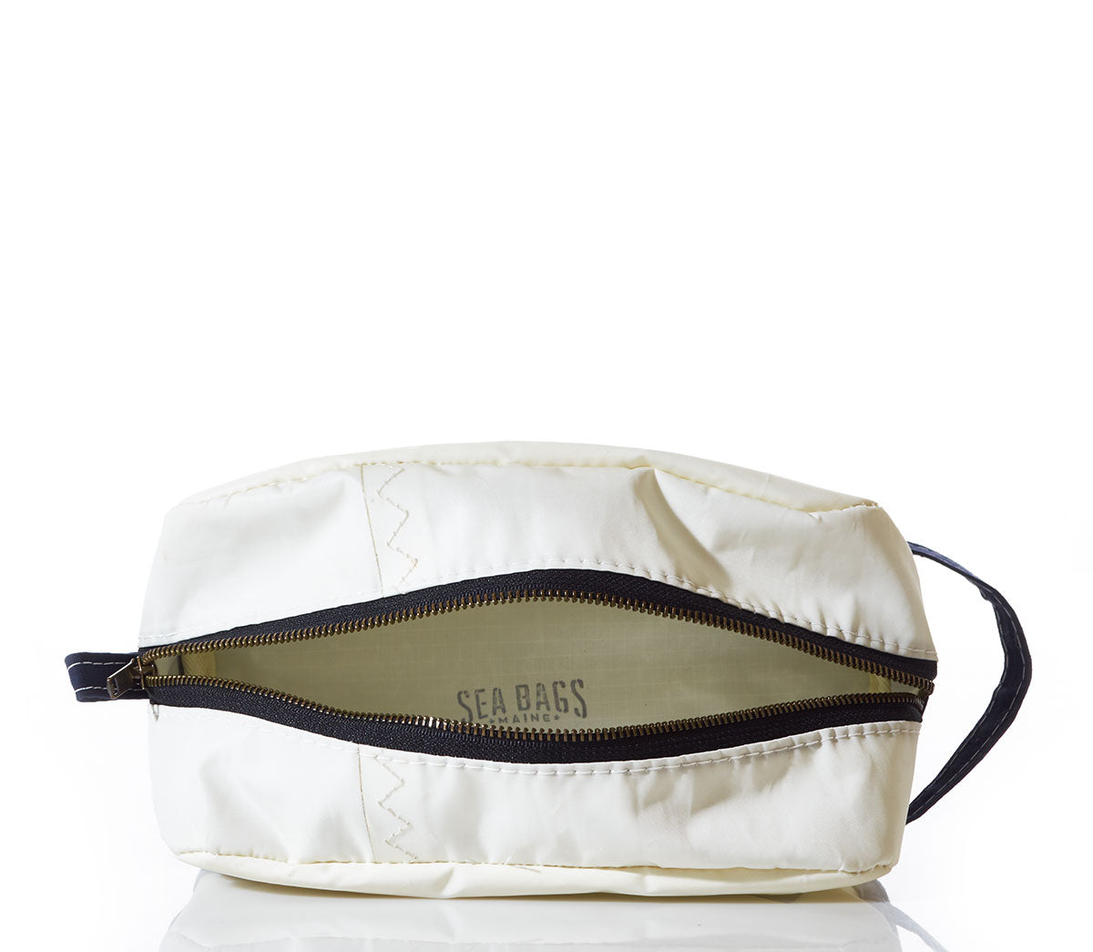 Chebeague Toiletry Bag by Sea Bags, featuring a black zipper partially open to reveal the printed Sea Bags logo inside, a small handle on the left side, and expertly crafted from durable Dacron sailcloth as part of the Chebeague collection—an excellent choice among seaworthy travel bags—set against a white background. by Sea Bags