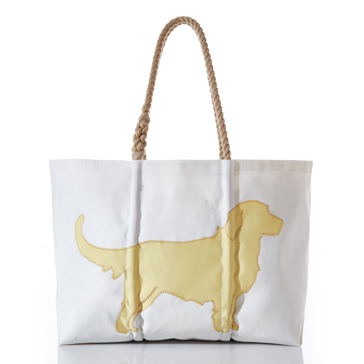 The Sea Bags Golden Retriever Large Tote is crafted from white recycled sail, featuring sturdy rope handles and a yellow stitched silhouette of a Golden Retriever on the front—making it the perfect accessory for dog lovers and their faithful companions. by Sea Bags