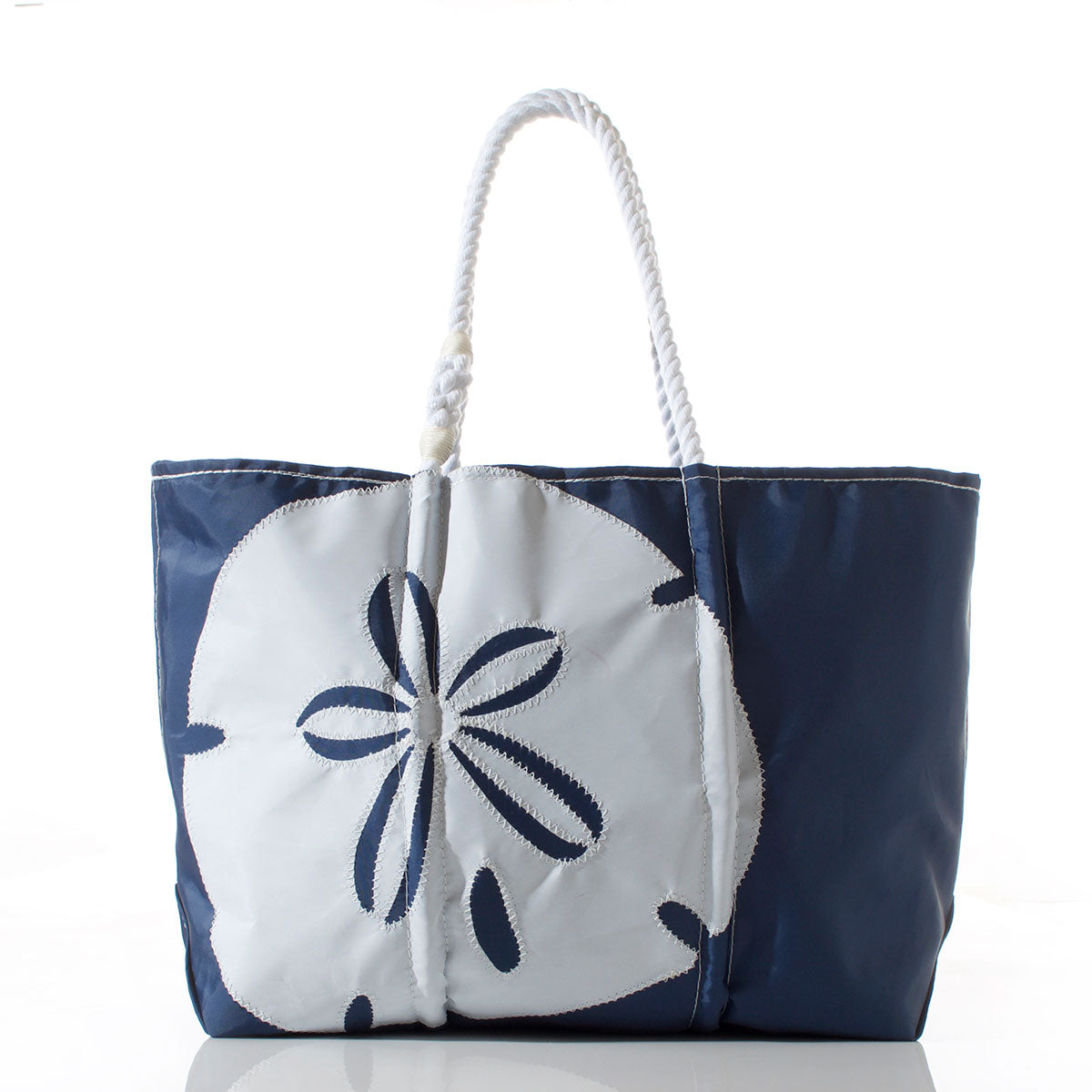 Sea Bags White on Navy Sand Dollar Large Tote, featuring durable white rope handles and a bold white sand dollar motif on navy, crafted from recycled sails for eco-friendly style, shown against a plain white background. by Sea Bags
