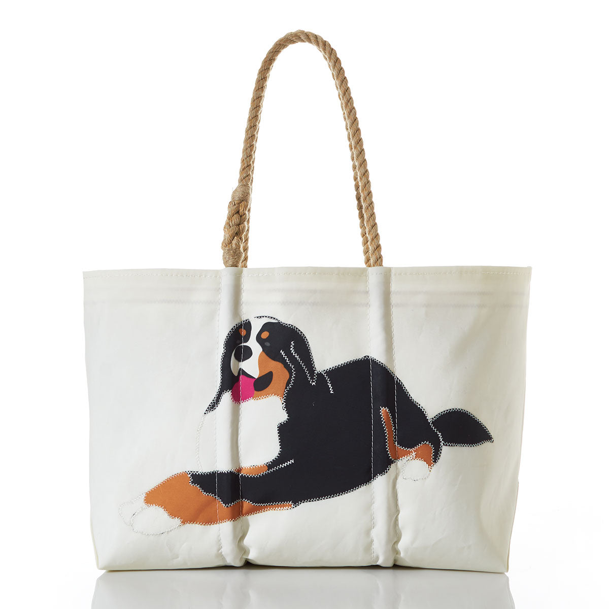 The Sea Bags Bernese Mountain Dog Tote with Clasp and Hanging Pocket is crafted from white recycled sail cloth, features sturdy rope handles, and displays an illustration of a black, brown, and white Bernese Mountain Dog lying down on the front. by Sea Bags
