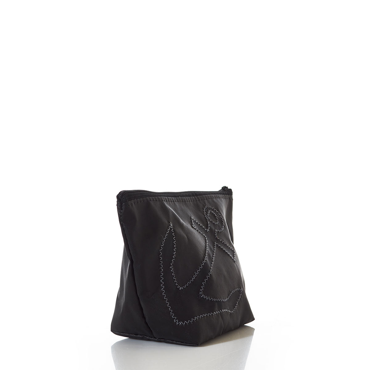 The Black-on-Black Anchor Cosmetic Bag by Sea Bags is crafted from recycled sailcloth and features a black zippered design with a stitched anchor outline. It is photographed on a white reflective surface against a plain white background. by Sea Bags