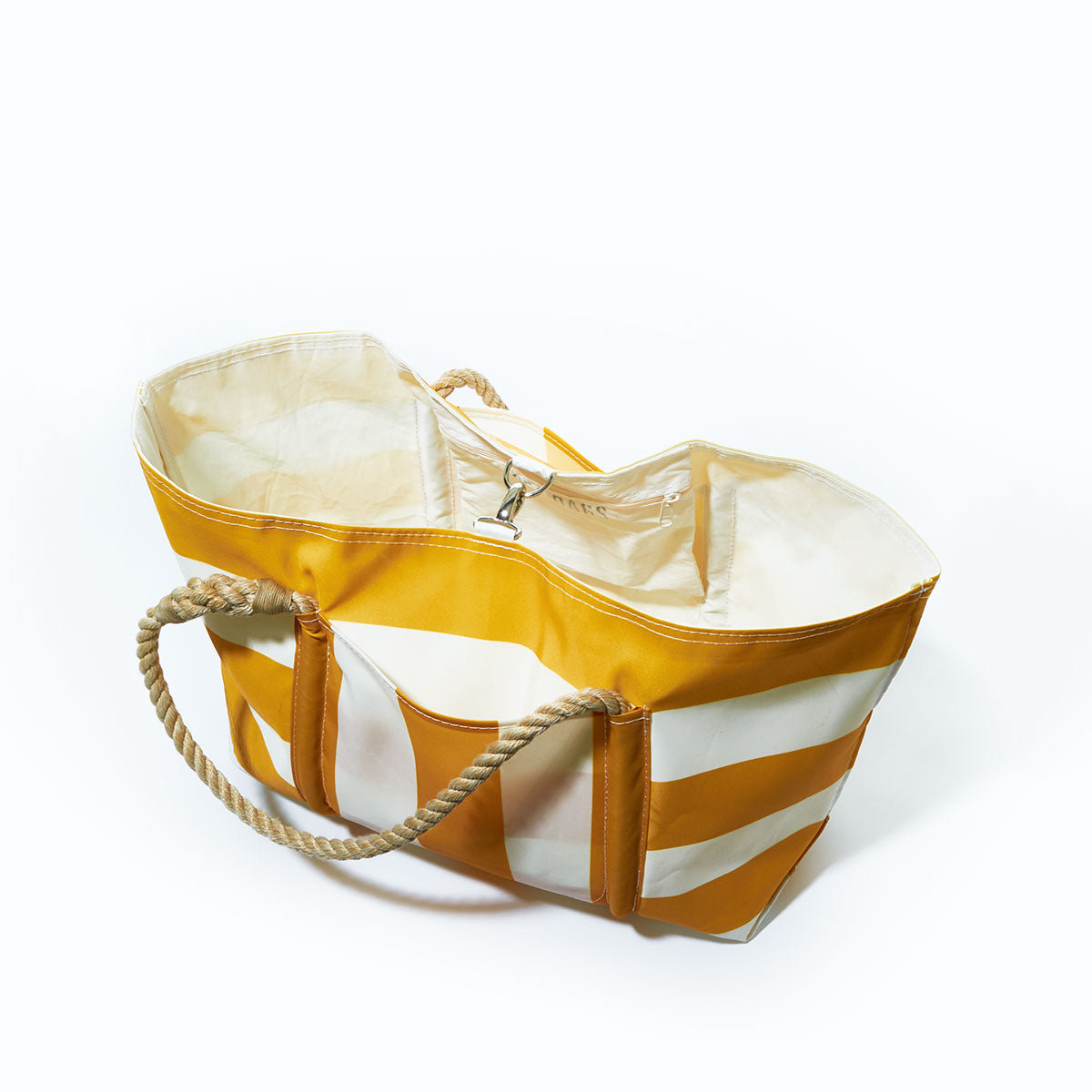 The Yellow Pier Tote from Sea Bags, crafted from recycled sail cloth with yellow and white stripes, features sturdy rope handles and a spacious exterior pocket. It is photographed from above on a white background. by Sea Bags