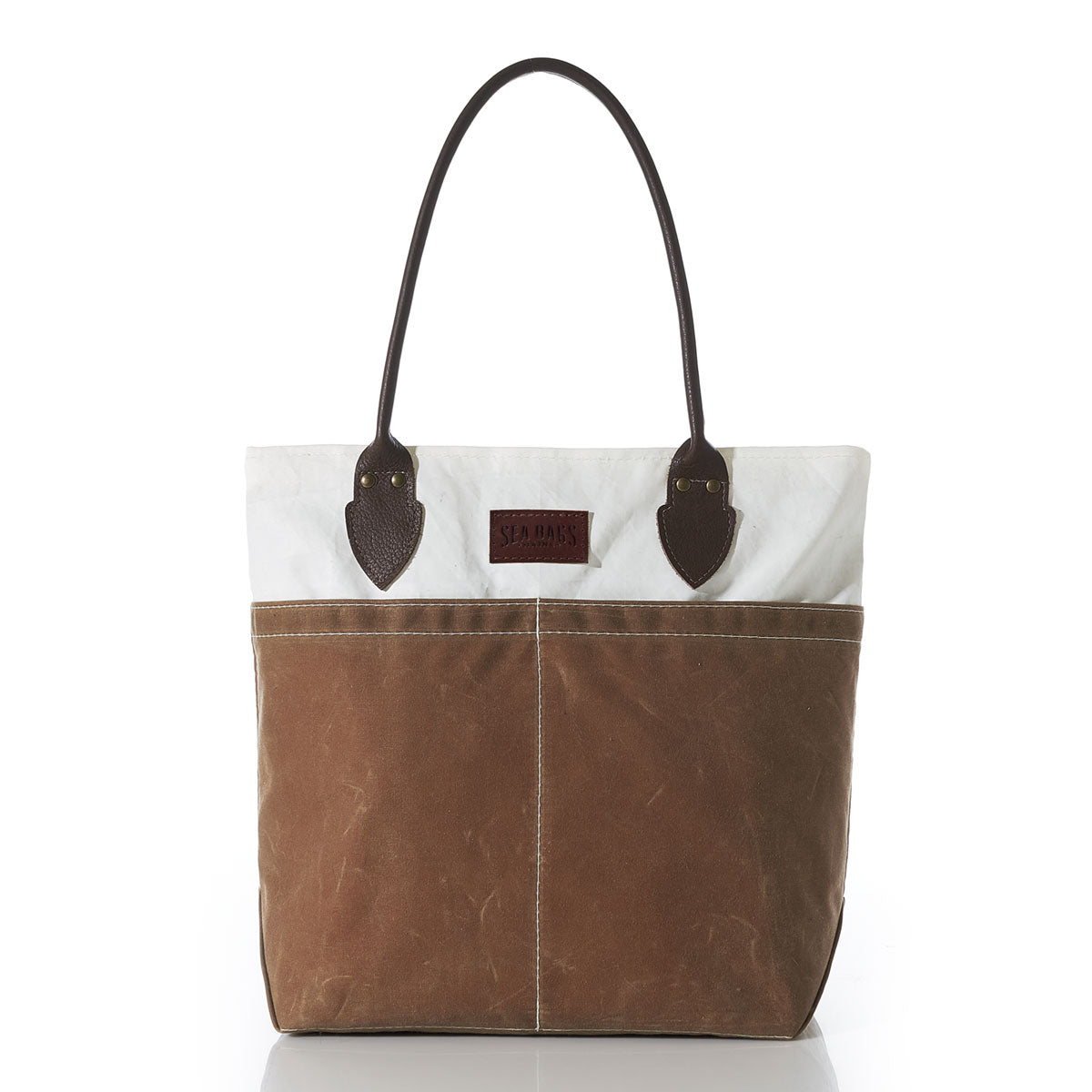 A Sea Bags Tan Chebeague Tote, showcasing dark brown leather handles, a white upper section crafted from recycled sail cloth, and a tan lower section made of durable waxed canvas, photographed against a white background. by Sea Bags