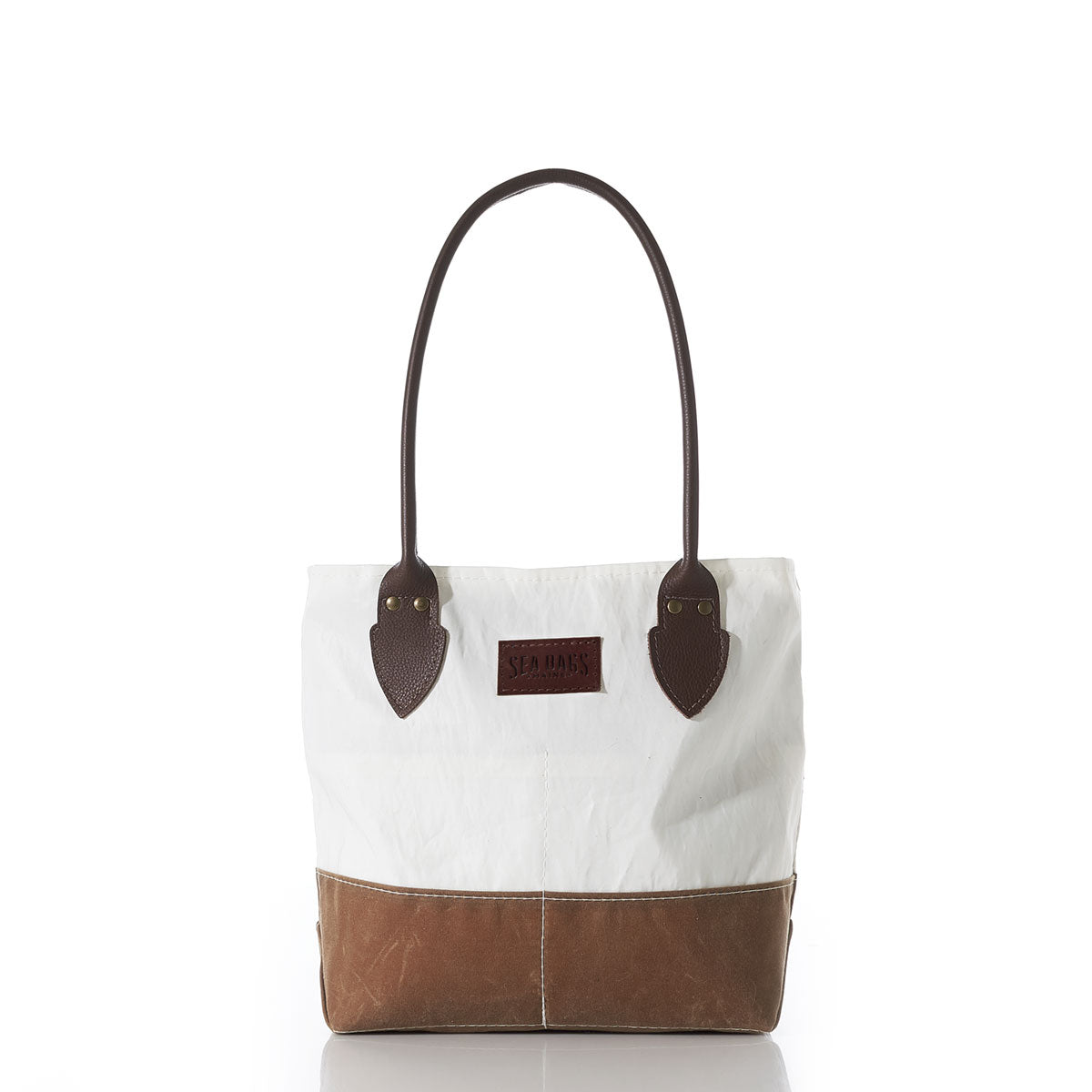 Tan Chebeague Handbag by Sea Bags, crafted from white and brown waxed canvas, featuring two dark brown leather handles, leather accents, and a rectangular brown Sea Bags logo patch on the front, photographed against a white background. by Sea Bags