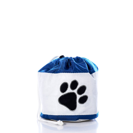 The Sea Bags Paw Print Ditty Bag is an eco-friendly white and blue drawstring pet bag, featuring a bold black paw print on the front and photographed against a white background. Crafted from recycled sail bags, this stylish accessory combines sustainability with thoughtful design. by Sea Bags