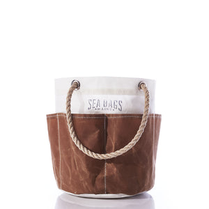 All Purpose Tan Tool Bucket Bag by Sea Bags, crafted from durable recycled sail cloth in brown and white canvas with rope handles, featuring the Sea Bags logo on the upper white section, photographed against a white background. by Sea Bags