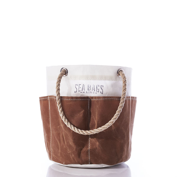 All Purpose Tan Tool Bucket Bag by Sea Bags, crafted from durable recycled sail cloth in brown and white canvas with rope handles, featuring the Sea Bags logo on the upper white section, photographed against a white background. by Sea Bags