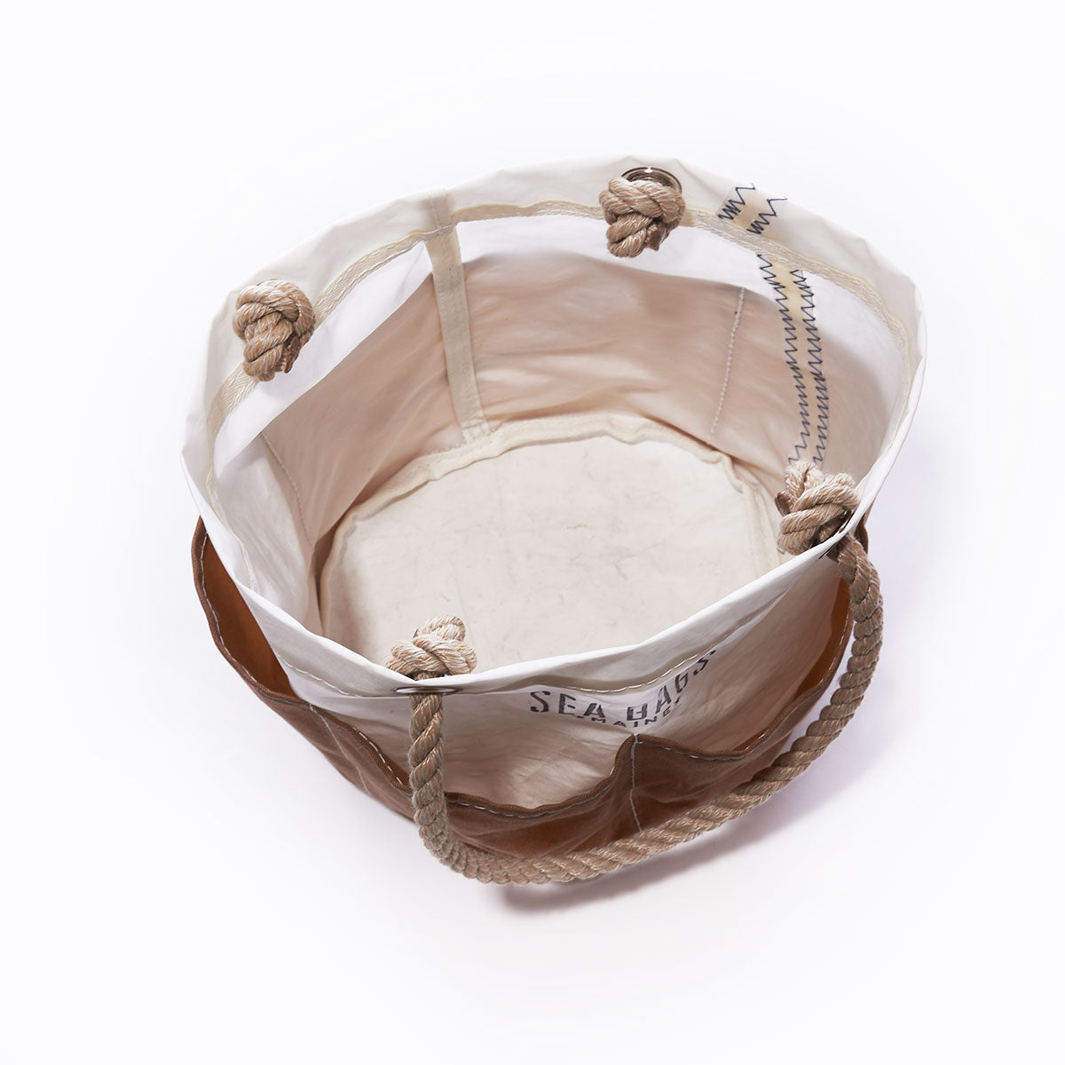 Open top view of the Sea Bags All Purpose Tan Tool Bucket Bag, featuring canvas and leather construction with rope handles and knotted rope attachments at the top, plus durable waxed-canvas pockets inspired by a classic workhorse bucket. by Sea Bags