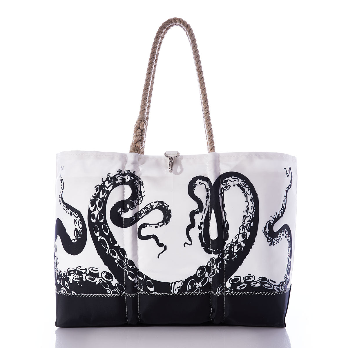 The Sea Bags Octopus Ogunquit Beach Tote features a white and black design with a rope handle, showcasing a vintage octopus tentacle illustration on the front. Crafted from recycled sail cloth, this distinctive beach bag blends style and sustainability for your coastal adventures. by Sea Bags