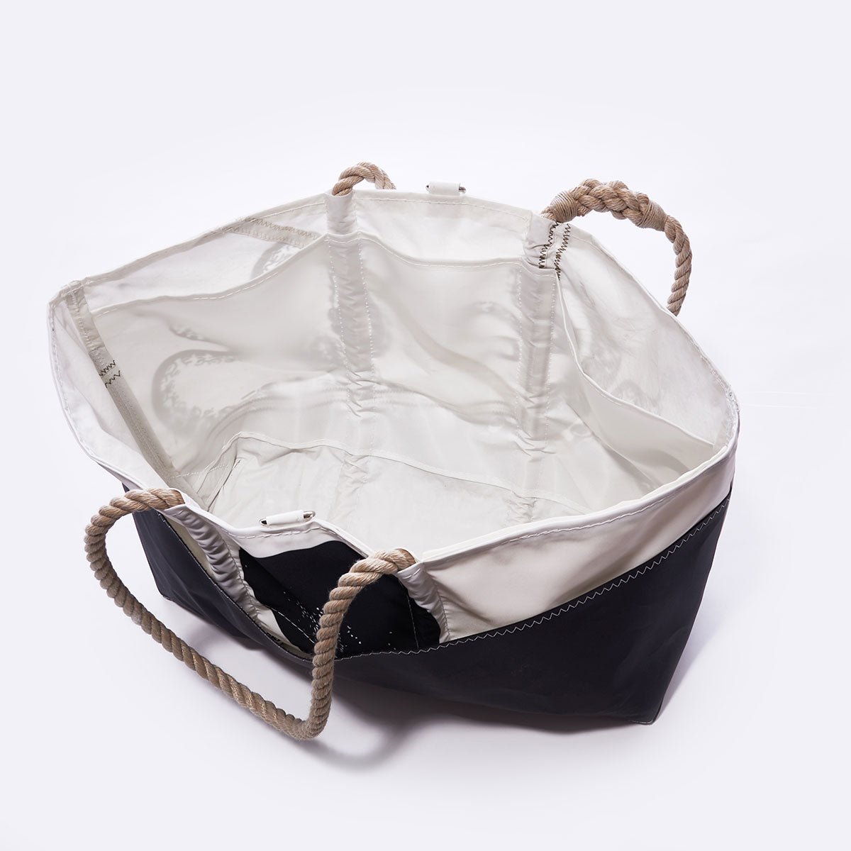 Open Octopus Ogunquit Beach Tote by Sea Bags, featuring black and white design with beige rope handles, expertly crafted from recycled sail cloth and photographed from above to reveal its spacious, empty interior against a plain background—ideal as a versatile beach bag. by Sea Bags