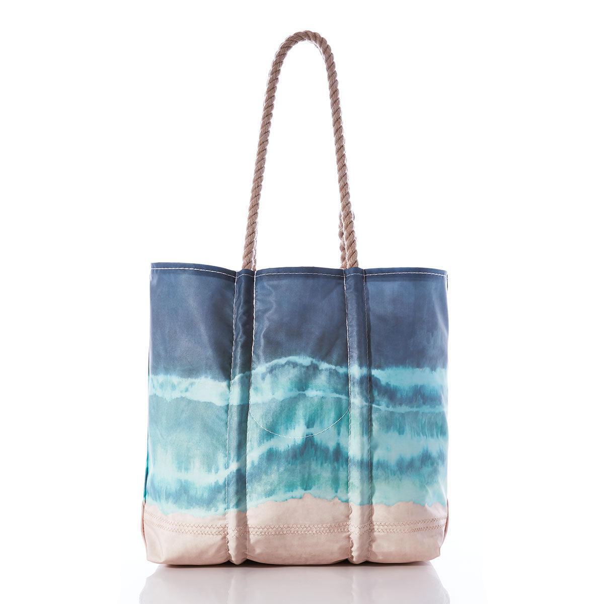 The Sea Bags Zip Top Shoreline Tie Dye Medium Tote showcases a blue and beige wave-inspired tie-dye pattern, complemented by two twisted rope handles. Crafted with the durability reminiscent of recycled sail cloth totes, this versatile beach bag is displayed against a white background. by Sea Bags